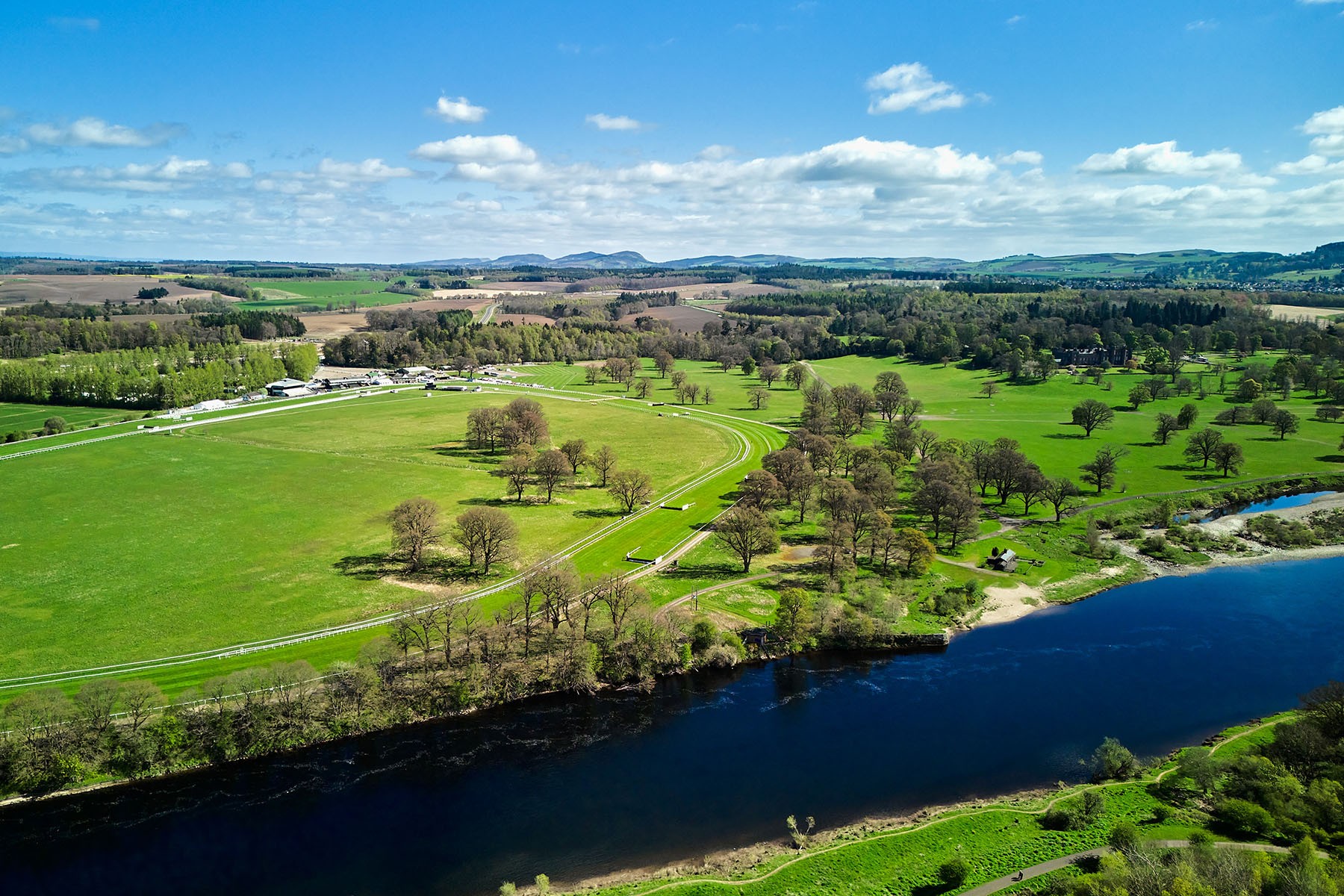 Perth Race course from the air showing River Tay, full track and Scone Palace parklands in April, trees not yet in full leaf